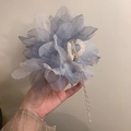 Close-up of large blue flower hair claw with elegant hanging pearl tassel detail - Blue