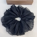 Detailed macro view of black oversized pleated chiffon hair scrunchie with soft fabric texture - Black