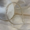 Detail view of cream marble pattern acetate headband on a white plaster statue - Mermaid White