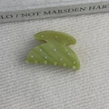Macro shot of light green acetate hair claw clip with marble texture and sparkling rhinestones - Green