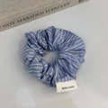 Blue and white striped fabric scrunchie with a handmade label on a clean background - Blue Striped Hair Tie