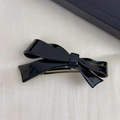 Macro view of a black resin bow hair clip with gold France Handmade lettering - Black