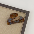 Detail view of acetate tortoise shell hair claw clip with unique blue marble pattern texture - Blue Brown Gradient