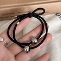 Close-up of black high-elastic hair tie with polished silver metal beads and tubes - Silver Ball Style