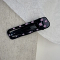Close-up of a black rectangular BB hair clip with pink polka dots on a linen background - Hollow Square Style