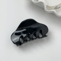 Detail of a minimalist black acetate hair claw clip on a stylish decorative plate - Small Black
