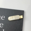 Detail view of rectangular marble texture hair clip with golden metal duckbill clamp - Yellow