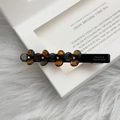 Detail view of handmade flower hair clip with tortoise shell texture and rhinestones - Blue Brown Gradient