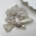 White organza scrunchie with satin rose and ribbon bow featuring a pearl drop charm - Off-white