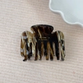 Detail of tortoiseshell acetate hair claw with golden Barrette La France lettering - Black and Coffee Striped