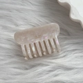 Détail d'une pince à cheveux en acétate rose avec motif marbré et texte doré élégant - Blanc