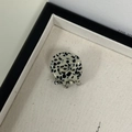 Detail of a mini round hair claw clip featuring black and white Dalmatian spot pattern - Black and White Spots