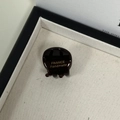 Detailed macro shot of dark brown acetate hair claw with gold France Handmade logo - Chocolate