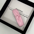 Close-up of pink PU leather knotted hair clip with elegant pleated texture on canvas - Pink