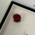 Macro detail of wine red acetate hair claw clip with golden handmade logo text - Burgundy