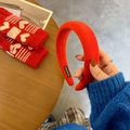 Detail of red thick sponge headband with Hand Made label and soft knit texture - Orange Red
