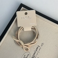 Detail of high-elasticity knitted hair bands in beige and khaki with bow on tray - Beige Series