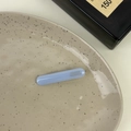 Light blue acetate hair clip featuring gold France Handmade logo on a ceramic dish - Blue
