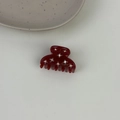 Detail view of the deep wine red acetate hair claw with sparkling rhinestone inlay accents - Burgundy