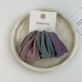 Detailed view of three Morandi color fabric scrunchies on white display card - Morandi Color