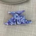 Detail view of purple marbled acetate butterfly hair claw clip on beige checkered fabric - Purple