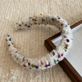 Close-up of thick cream knit headband with colorful yarn dots and soft wool texture - Beige Apricot