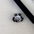 Detail of a handmade tortoise shell pattern acetate hair claw on a knit background - Black and White Marble