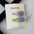 Close-up of colorful felt ball hair clips with metal BB clips on a display card - Plush Ball Hair Clip / Gray and Blue Pom-pom