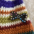 Cute black resin bow hair clip with colorful stitching and silver star accent - Black