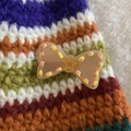 Pastel pink acrylic bow hair clip with yellow star and colorful stitched edges - Khaki