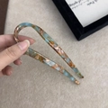 Detail view of the tortoiseshell acetate U-shaped hair stick with a smooth polished finish - Mint Green Brown Gradient