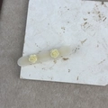 Detail view of acetate rose flower hair clip with vintage cream finish and wavy edges - Mermaid Color