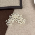 Detail of hollow floral hair claw with sparkling rhinestones and cream acetate finish - Mermaid Color