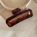 Close-up of tortoise shell pattern hair claw clip with glossy finish and metal spring - Tortoiseshell Rectangle