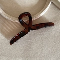 Close-up of amber tortoiseshell hair claw clip with large twist design and strong spring - Tortoiseshell Cross