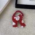Detailed view of plush red bow hair clip with white dots and crystal center accent - Red Hair Tie