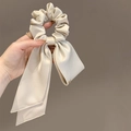 Elegant champagne satin scrunchie with long bow ribbons and pearl edge detailing - Apricot