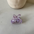Detail of a purple marbled acetate hair claw clip with an elegant hollow butterfly design - Purple