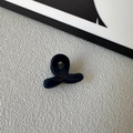 Close-up of small navy blue acetate hair claw clip with golden handmade lettering - Dark Blue