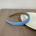 Detail of blue striped headband fabric and anti-slip brown inner lining on wood table - Blue Multi-Colored Stripes