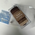 Detail of high elasticity hair ties in earthy tones inside a clear storage box - Brown