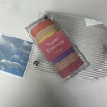 Macro view of multi-color elastic hair ties in a clear acrylic storage box with brand sleeve - Macaron Color