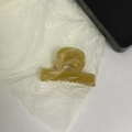 Close-up of amber acetate hair claw clip with Barrette la France logo on white paper - Brown