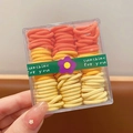 Set de gomas para el pelo color caramelo en caja transparente con tonos naranja y amarillo - Serie Amarillo Naranja