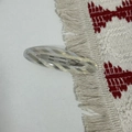 Detail view of oval acetate hair clip with classic diagonal stripes and engraved lettering - Iridescent White