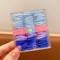 Set de gomas de pelo azules y violetas para niñas en caja cuadrada con detalle de flor azul - Serie Azul