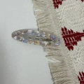 Macro detail of oval acetate hair clip with marble texture and silver metal back clip - Floral Purple