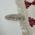 Macro shot of oval acetate hair clip with marble pattern and silver metal spring clip - Marble Pattern Style / Milk Tea