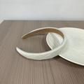 Padded white headband with twill fabric texture and brown non-slip lining on wood surface - White Pinstripes