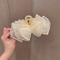 Detailed view of cream organza bow hair claw clip with faux pearls decoration - Off-white